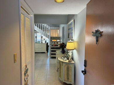 Hallway featuring light tile patterned floors