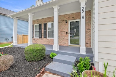 Doorway to property featuring covered porch, brick siding, and a chimney