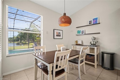 Dining space featuring baseboards and light tile p