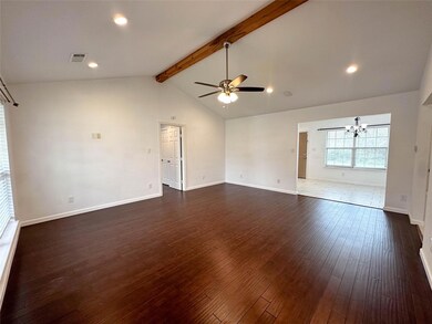 Tiled empty room with high vaulted ceiling, beam ceiling, and ceiling fan