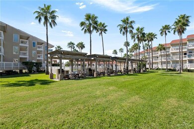 View of property's community featuring a lawn and a pergola