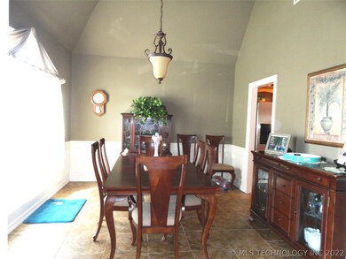 Spacious formal dining room with high ceiling, bea