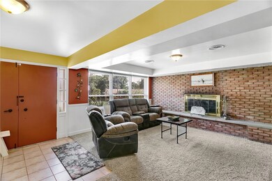 The brick fireplace wall is the focal point upon e