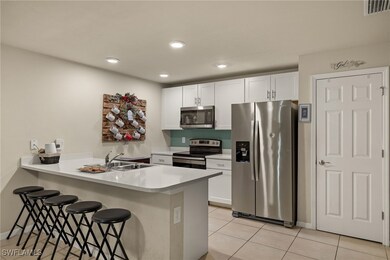 Kitchen featuring a kitchen bar, kitchen peninsula