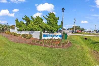 Community / neighborhood sign with a lawn and fenc