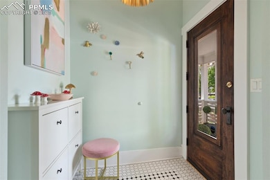 Spacious entry featuring refinished original front door.