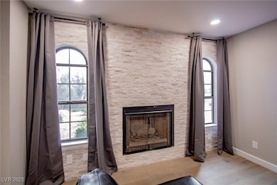 Detailed view of wood finished floors, a fireplace