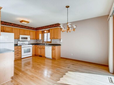 Kitchen/dining combination with wood flooring