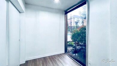 Empty room with floor to ceiling windows, over loo