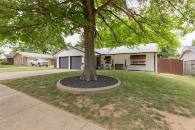Ranch-style house with driveway, a garage, and brick siding
