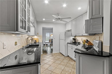 Kitchen featuring white cabinets, backsplash, ceil