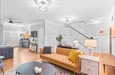 Living room with ornamental molding, ceiling fan w