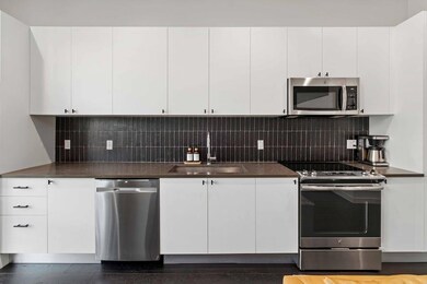Kitchen featuring stainless steel appliances, whi