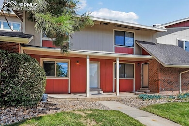Townhome / multi-family property featuring covered