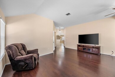 Sitting room featuring dark wood-style flooring, v