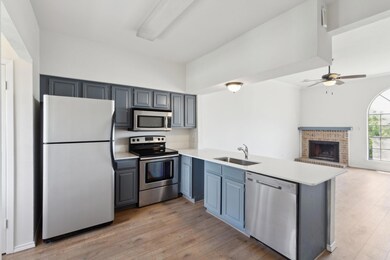 Kitchen with light wood finished floors, stainless