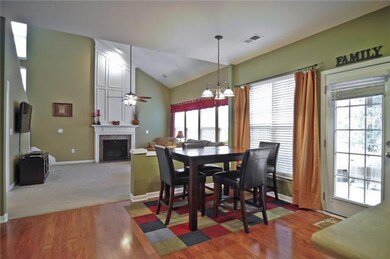 The bright eat-in area of the kitchen looks out to the lush back yard
