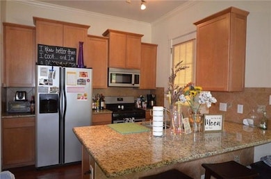 Kitchen featuring light stone countertops, a peni