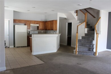 Kitchen featuring freestanding refrigerator, under
