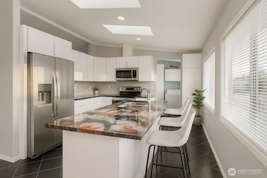 Gorgeous remodeled kitchen with great natural light, island counter and breakfast bar.