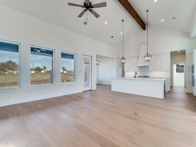 Unfurnished living room with high vaulted ceiling, light wood-style flooring, ceiling fan, beam ceiling, and recessed lighting