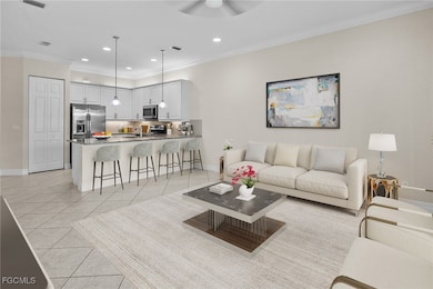 Living area featuring light tile patterned flooring, ornamental molding, recessed lighting, and ceiling fan