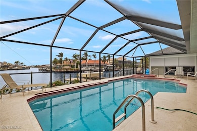 View of pool with a lanai, an in ground hot tub, a