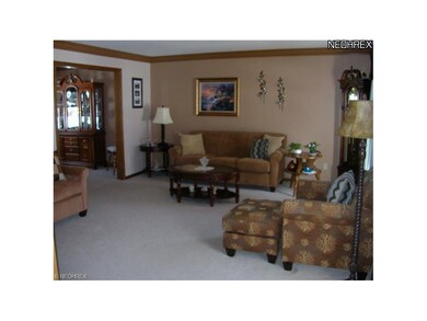 A spacious Living Room with large crown molding gr