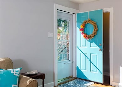 The storm door allows plenty of sunshine into the living room.