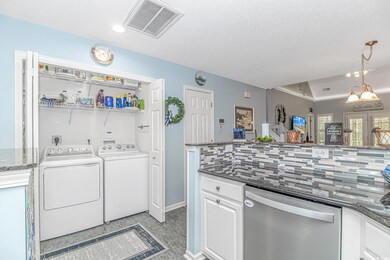 Laundry room featuring light tile patterned floori