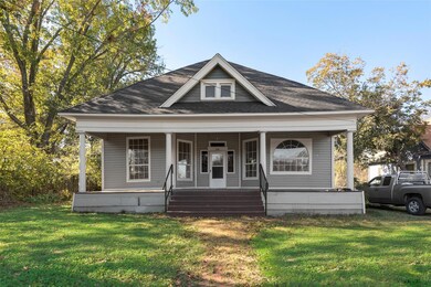 Bungalow with a porch and a front lawn