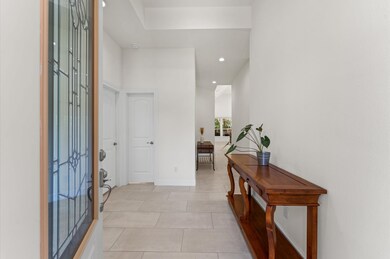 Bright entryway with tiled flooring and high ceili