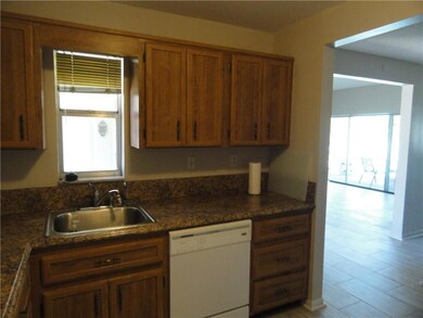 Kitchen  window view of front door. Kitchen is adj