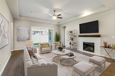 Gather the family and guests together in your lovely living room! Featuring high ceilings, dark stained ceiling fan with lighting, custom paint, gorgeous flooring, fireplace with mantel and large windows that provide plenty of natural lighting throughout the day.
