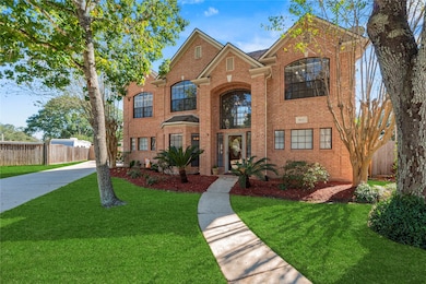 2-story brick home with lovely curb appeal. Grass has been digitally enhanced to show potential.