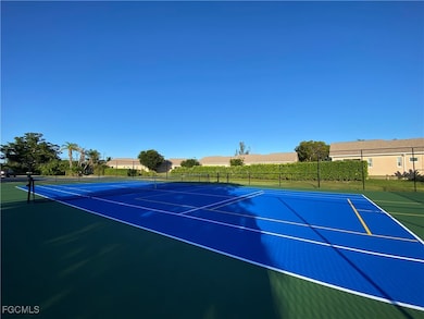 View of tennis court with community basketball court