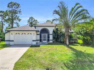 View of front of house with stucco siding, a garage, a front yard, concrete driveway, and roof with shingles