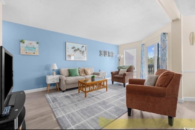 Living area featuring a textured ceiling and light wood finished floors