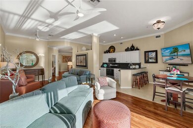 Living area with ceiling fan, visible vents, and l
