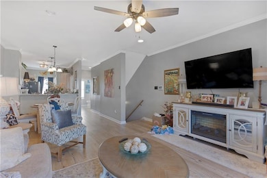 Living room with baseboards, ornamental molding, c