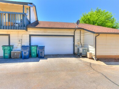 Garage with cooling unit and asphalt driveway