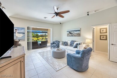 Living room featuring a ceiling fan, light tile pa