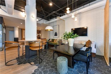 Common area featuring a towering ceiling and brick wall