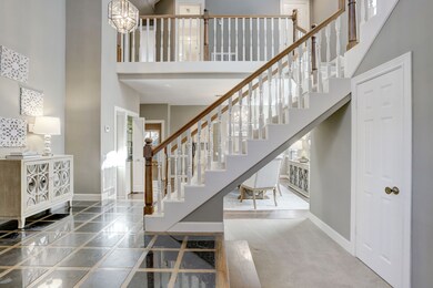 Dramatic staircase with high a ceiling.