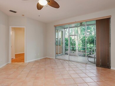 Tiled spare room featuring a wealth of natural lig