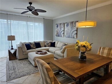 Living room with ornamental molding, a ceiling fan