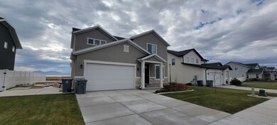 Traditional-style home with stucco siding, a garage, concrete driveway, stone siding, and a mountain view