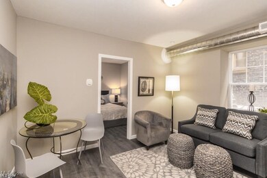 Living room with dark hardwood / wood-style flooring