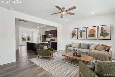 Living area with ceiling fan, dark wood-type floor