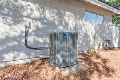Exterior view of stucco siding and a cooling unit